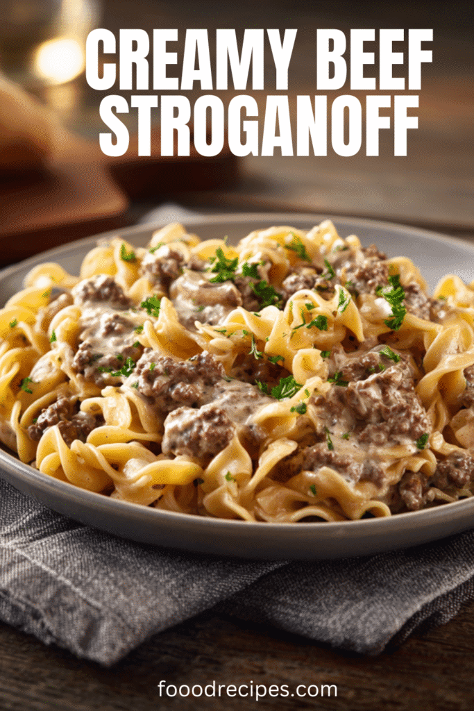 Creamy ground beef stroganoff served over egg noodles in a rustic bowl, topped with fresh parsley