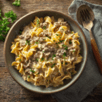 Creamy Ground Beef Stroganoff in rustic bowl