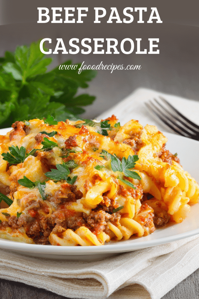 Beef pasta casserole with melted cheese and fresh parsley served on a white plate
