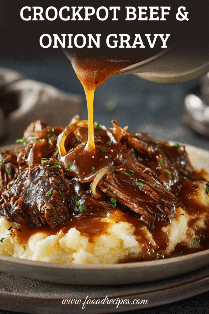 Slow cooker beef and onion gravy poured over mashed potatoes comfort meal.